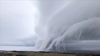 Shelf cloud formation crosses over water