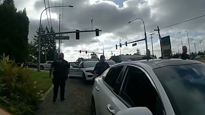 Police officers standing next to stolen car