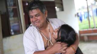 Lazaro Kamlem, 47, cacique of Palmeira village, hugs his daughter Ludmila, 10, at their house in Xokleng Laklano indigenous land, Jose Boiteux, Santa Catarina state, Brazil, August 19, 2021.