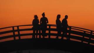 People on a bridge at dusk
