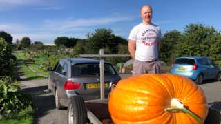 Man with a giant pumpkin