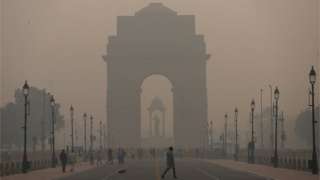 Pedestrians walk along a road near the India Gate amid heavy smog in New Delhi. Delhi's air quality remains "severe", accounting for 30 per cent of the PM2.5 pollution in the capital, Air Quality Index (AQI) at Noida (UP) is 529, 478 in Gurugram (Haryana) and 534 near Dhirpur, all in 'Severe' category. (Photo by Amarjeet Kumar Singh/SOPA Images/LightRocket via Getty Images)