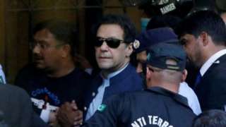 Security officers escort Pakistani former Prime Minister Imran Khan as he appeared in Islamabad High Court, Islamabad, Pakistan, May 12, 2023