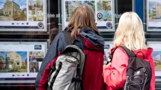 People look at properties in the window of an estate agent in Holmfirth, Britain, on 29 September 2022