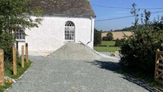A mound of gravel outside the chapel