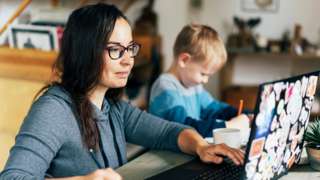 Stock shot of women working from home with a child