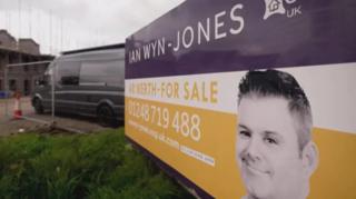 Estate agent board with large image of Ian Wyn-Jones Jones