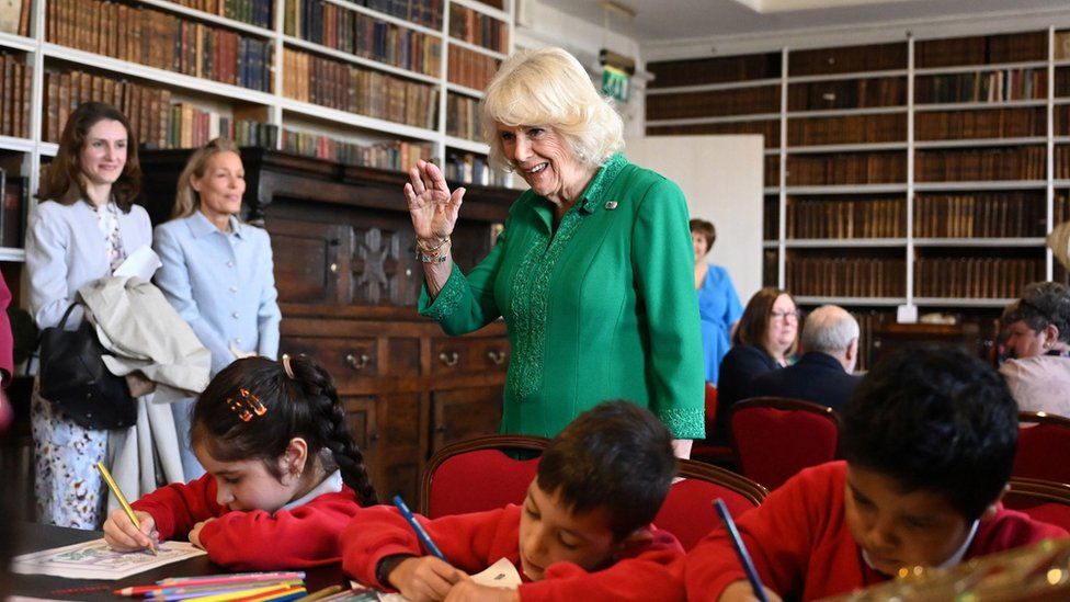 Queen Camilla with local school children during a visit to Robinson Library, Armagh, Co Armagh,