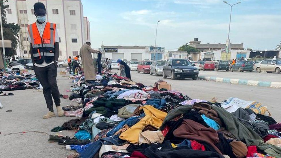 People help themselves to donated clothes in Derna