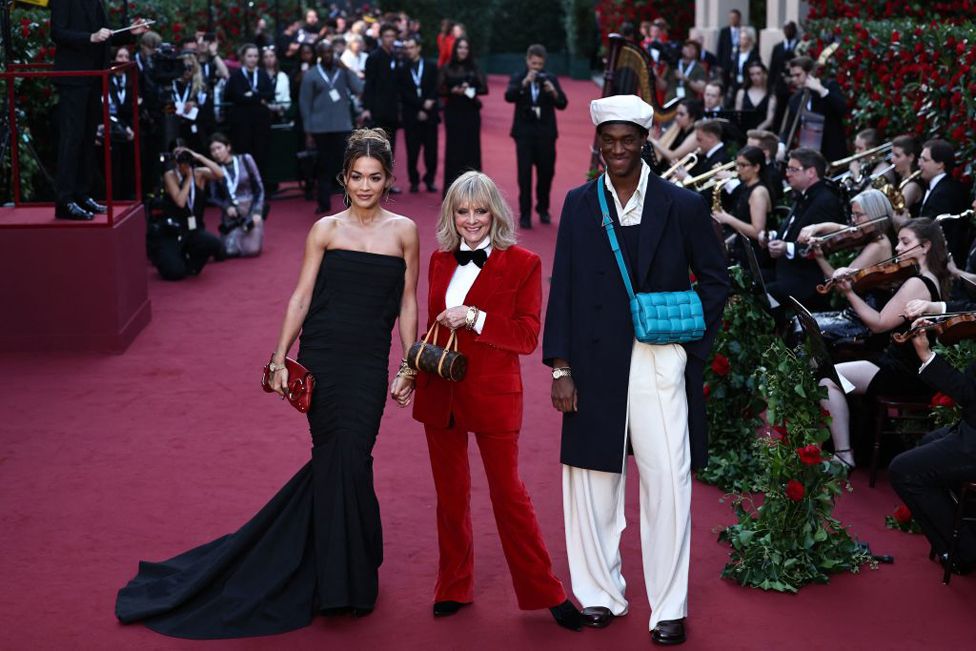 Singer Rita Ora, Twiggy and Wisdom Kaye pose for a photo as they attend Vogue World