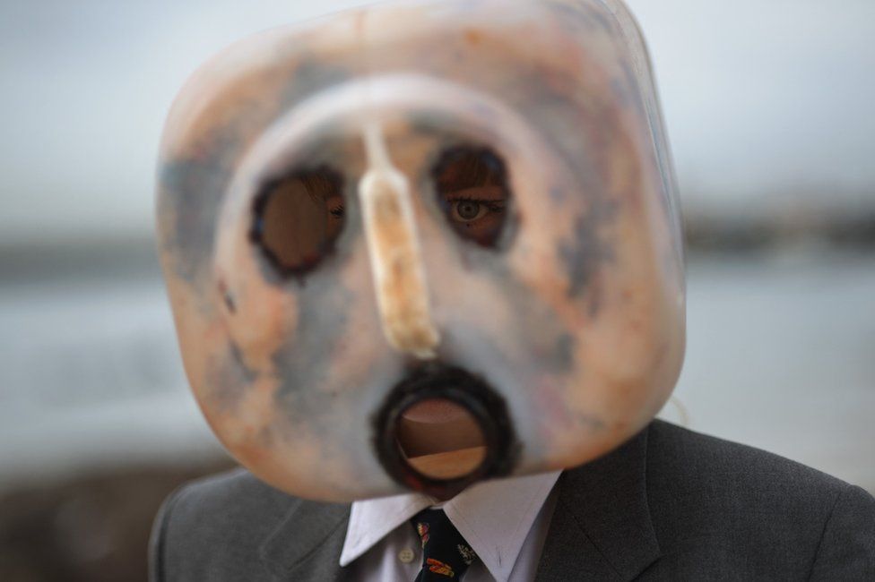 Man with a plastic mask on and a dark suit - 5 June.