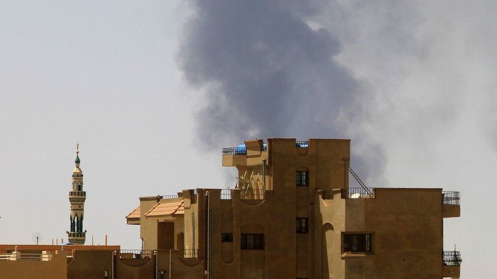 Smoke billows over residential buildings in Khartoum on May 1, 2023 as deadly clashes between rival generals' forces have entered their third week. -