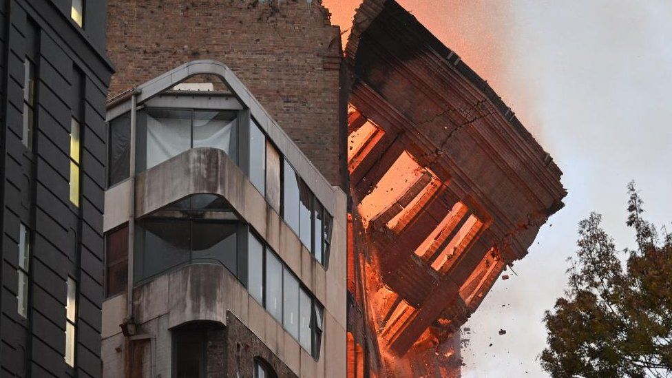A wall collapses during a building fire in the Central Business District of Sydney