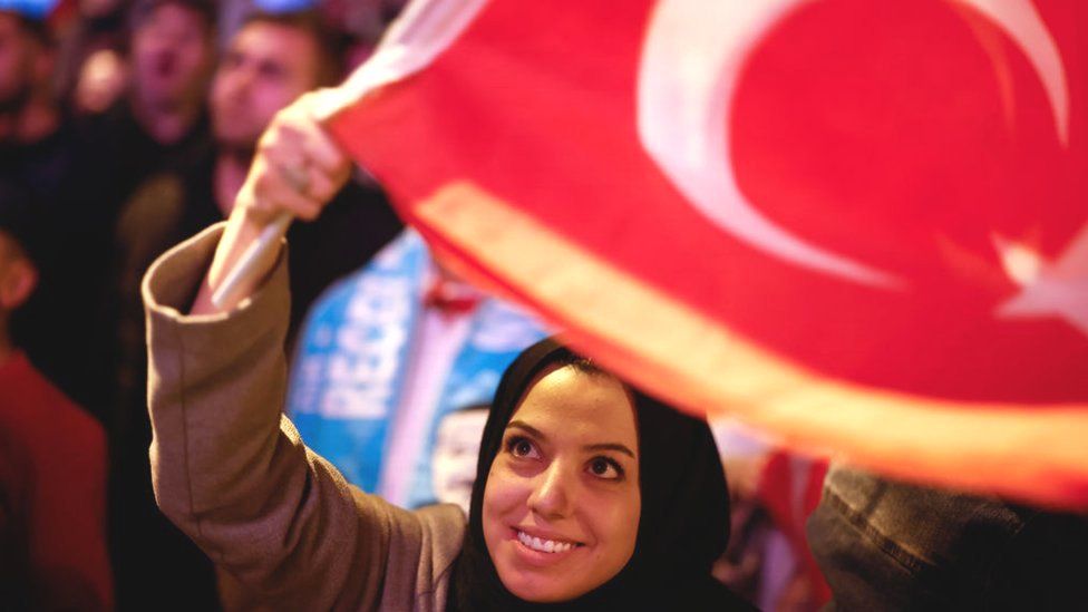 Supporters of Turkish President Recep Tayyip Erdogan celebrate at the AK Party headquarters on 15 May 15 in Istanbul