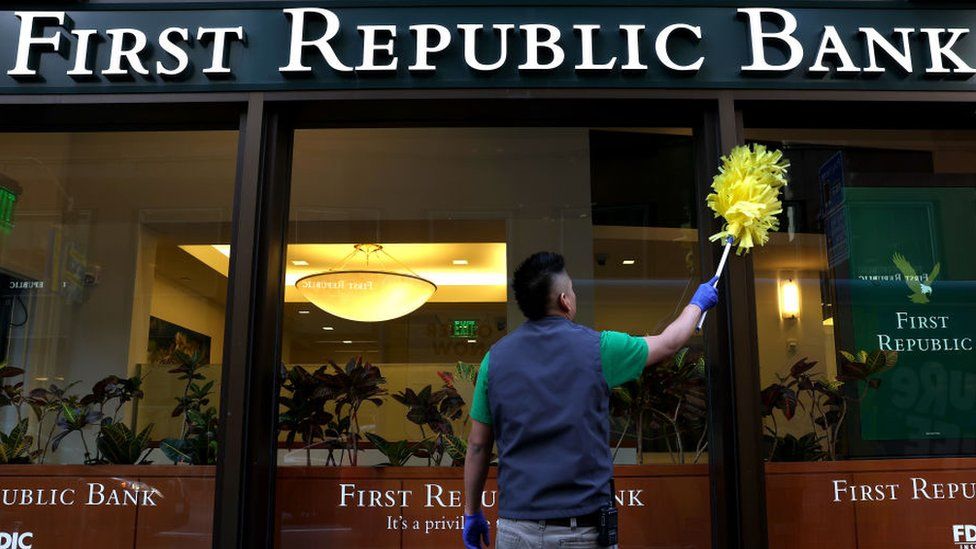 A worker cleans the exterior of a First Republic Bank branch in San Francisco, California.