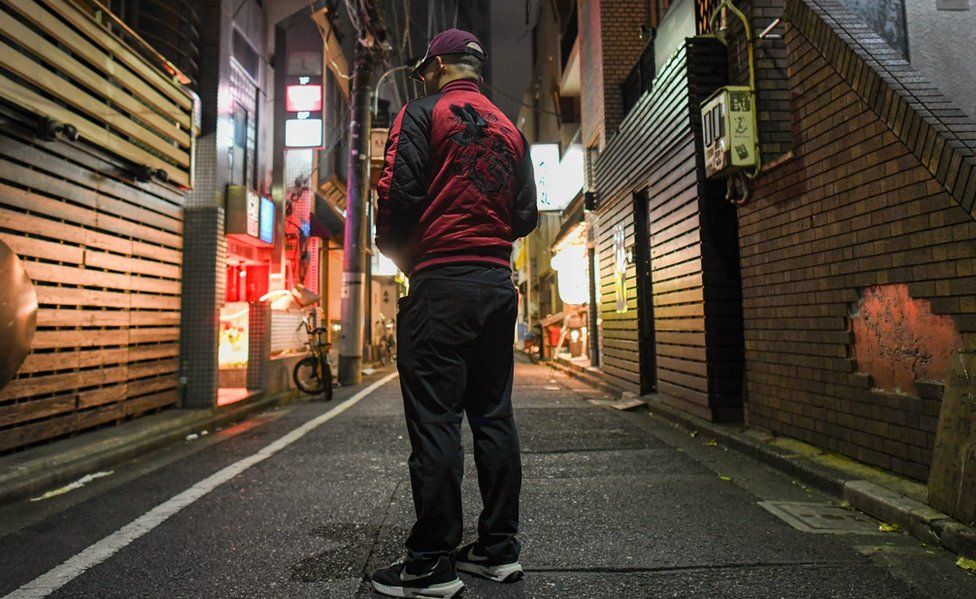 Image of the BBC's undercover reporter, photographed from behind on a Tokyo street