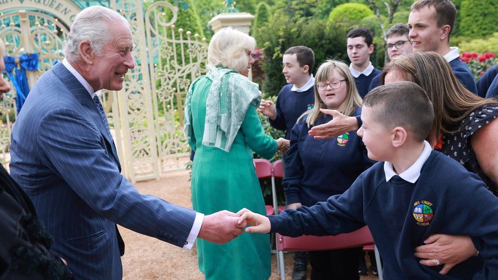 King Charles and Queen Camilla greeting school children at visit to a newly-created Coronation Garden in Newtownabbey,