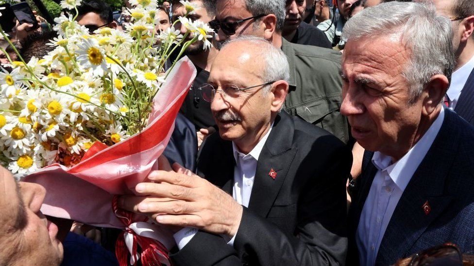 Kemal Kilicdaroglu receives flowers from a well-wisher after casting his vote at a polling station in Ankara