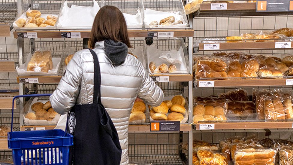 Customers shop for bakery products at Sainsbury's supermarket in London, Britain, 15 February 2023